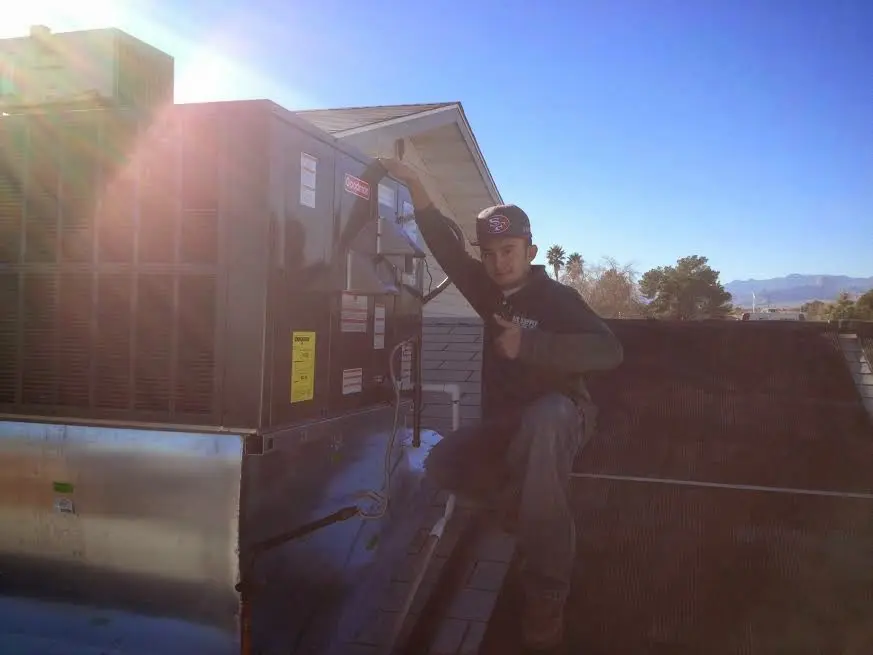 HVAC technician performing HVAC Inspection on a rooftop unit in Moorpark
